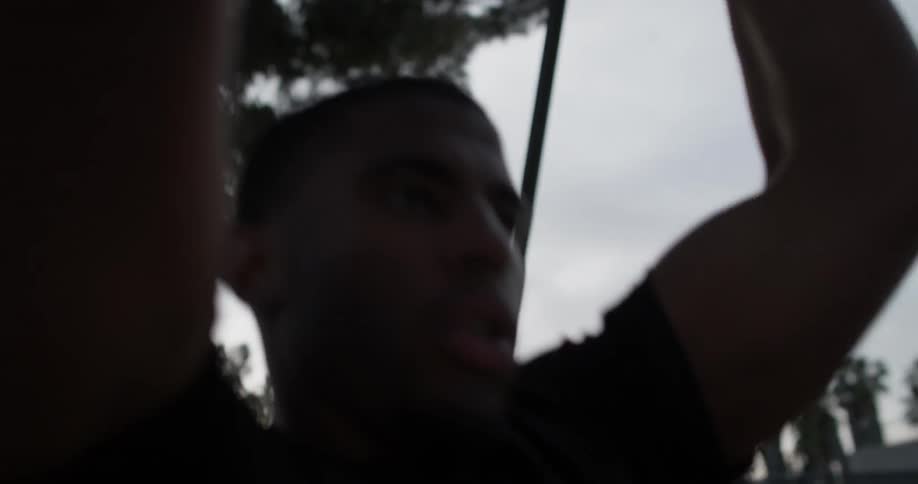 A man does pull ups on rings