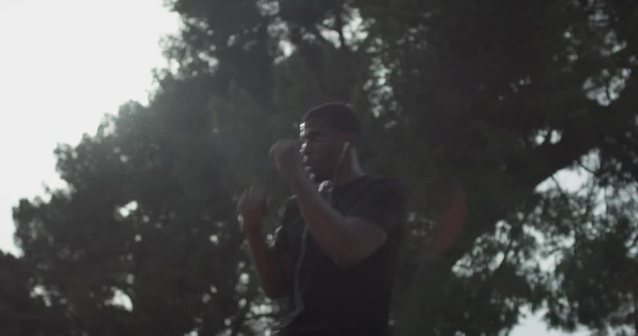 A man with earbuds making quick jabs