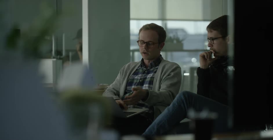Two men are discussing work