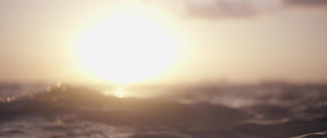 The sun setting over ocean water