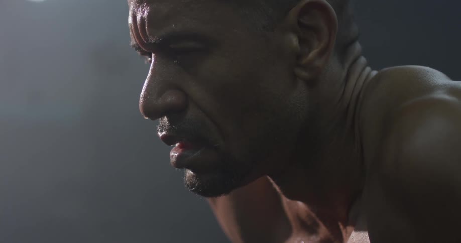 A man is sweating and glancing down