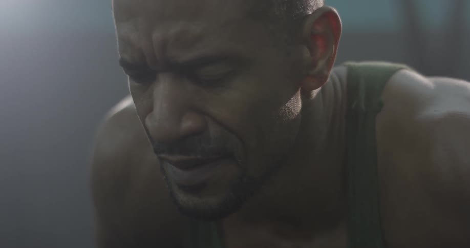 A man doing pushups in a gym
