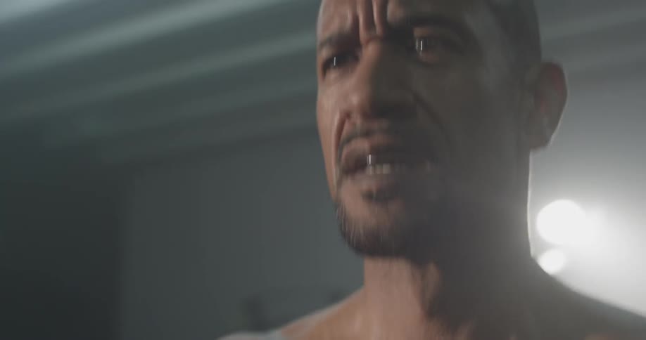 A man in a gym shouting while working out