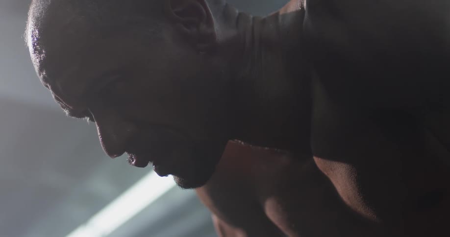 Shirtless man breathes heavily