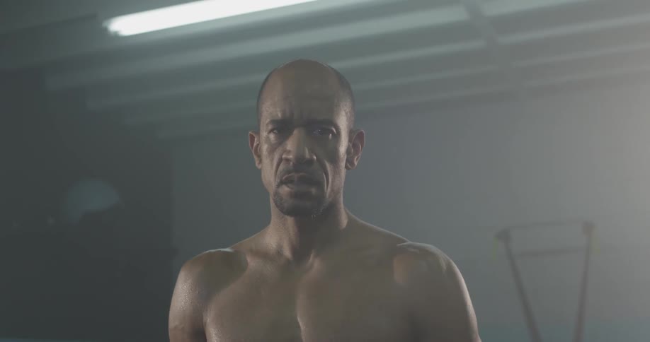 A man with pain on his face looks straight ahead