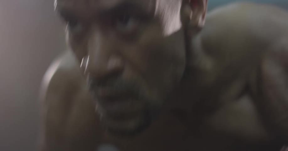 A man doing pushups in a gym