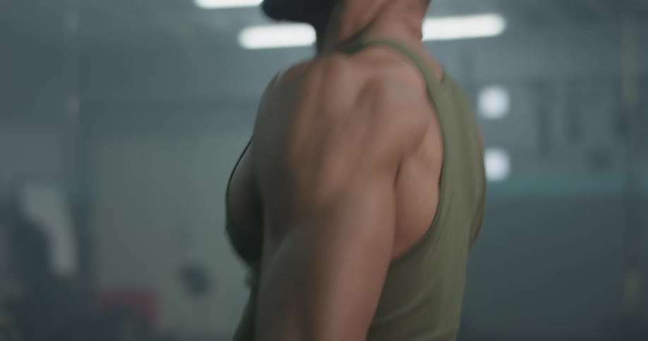 A man catches his breath after exercising in a gym