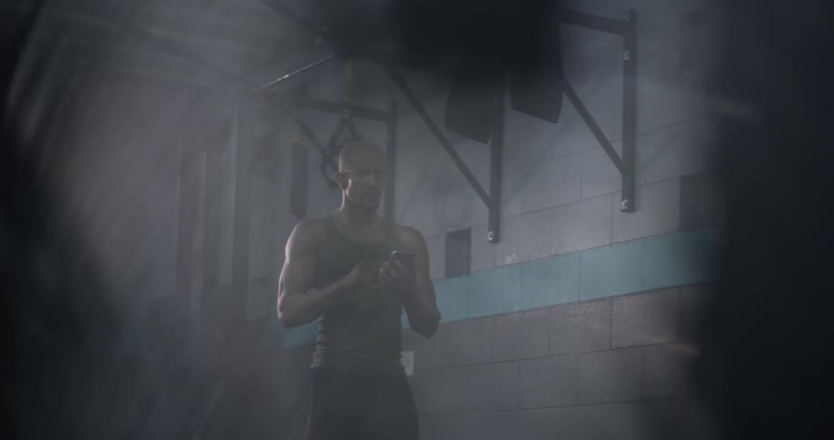 A man walking up to pick up his phone at the gym