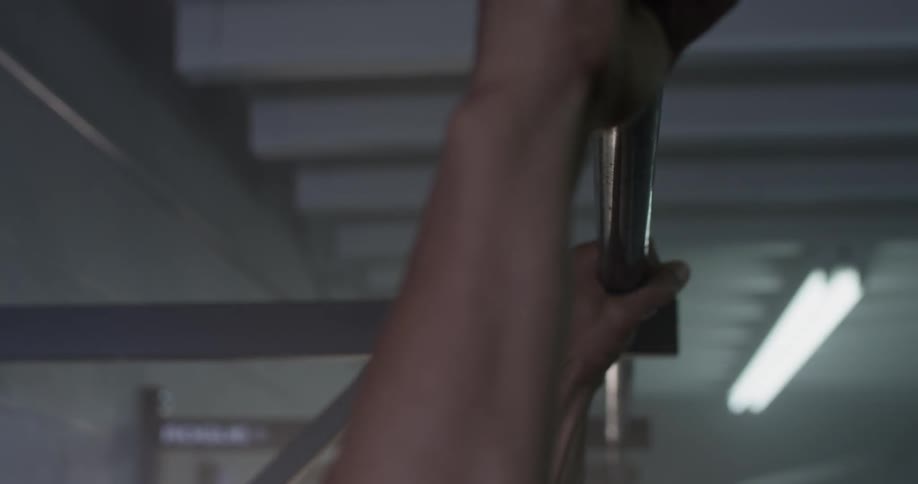 Man doing pull ups in a gym