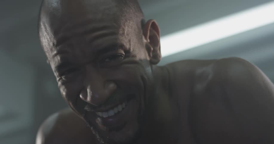 Man smiles and laughs looking up