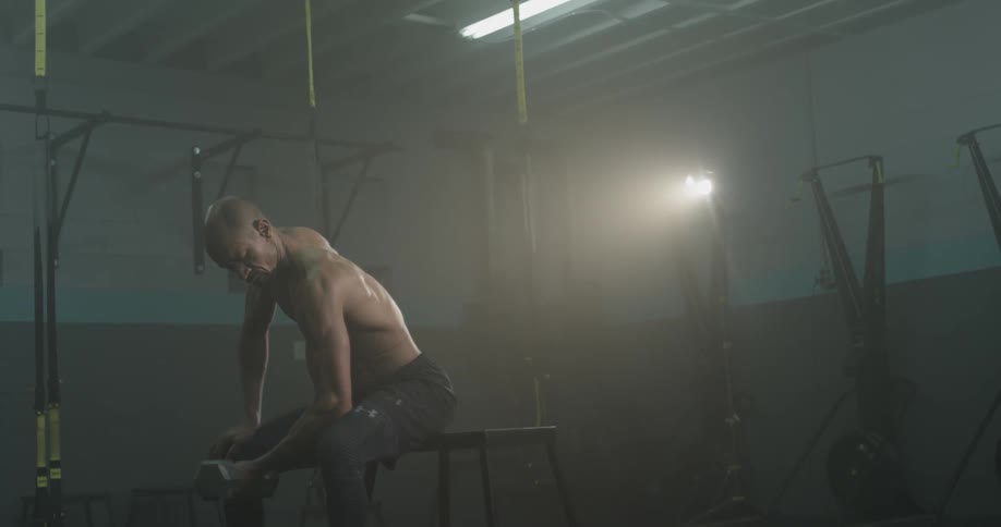 A man curling a barbell in a gym