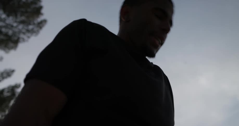 A man doing push ups on large bars outside