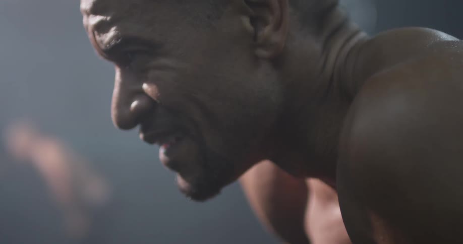 A man smiling while he stretches
