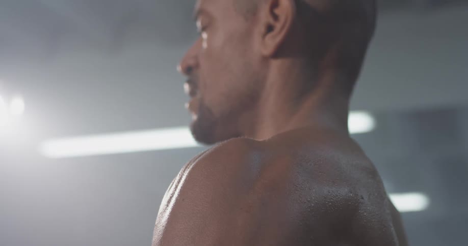 A man is standing up and is sweating