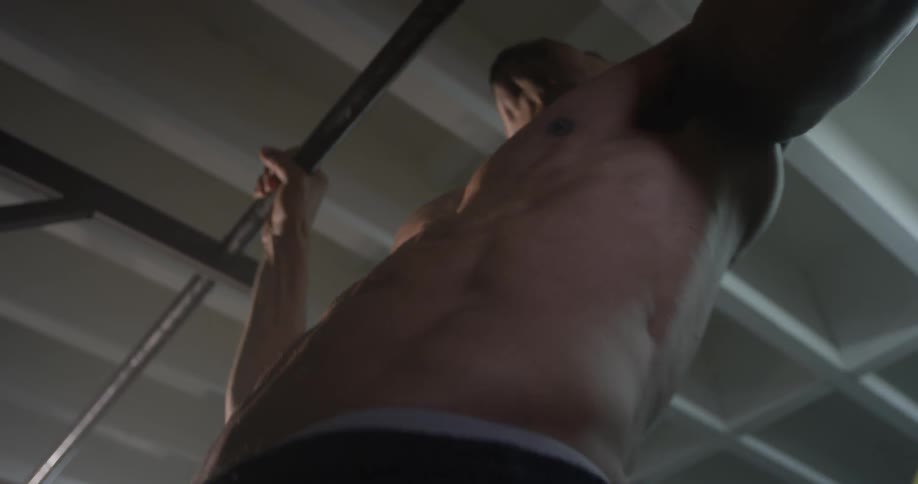A man does pull ups on a bar