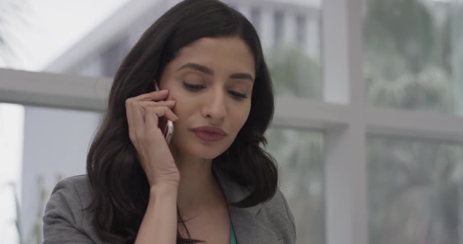 A woman checking her phone while in the office
