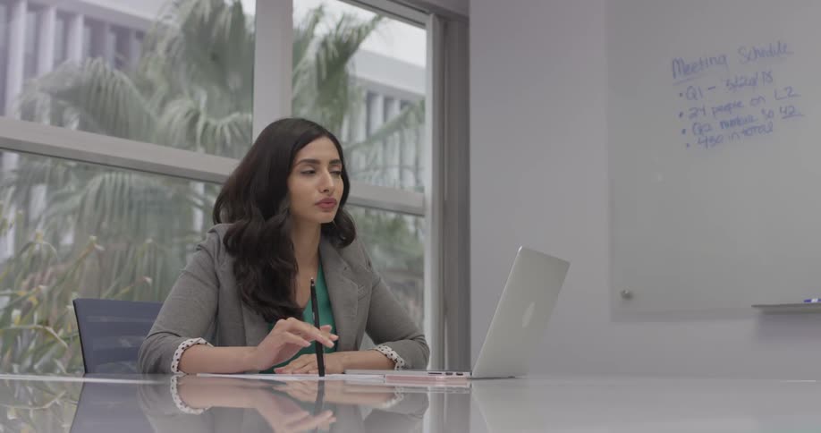 Woman thinking and writing on a piece of paper