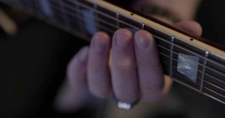 A person playing an electric guitar