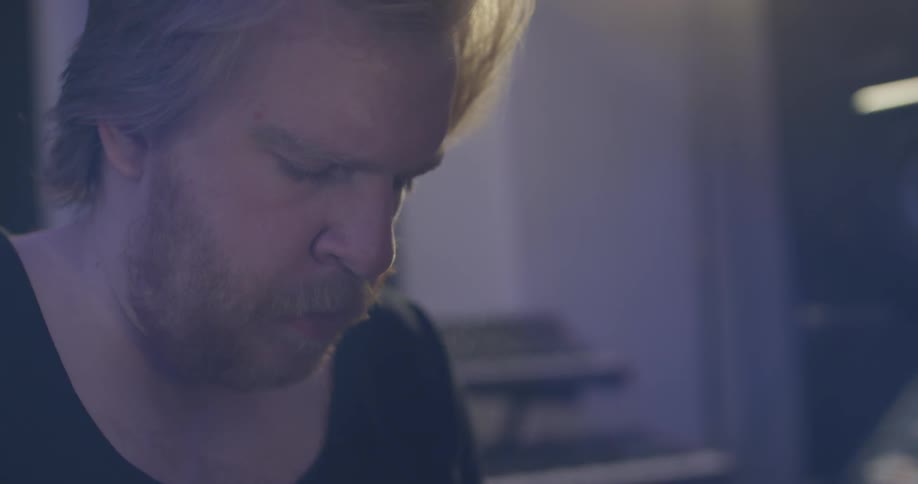 A man mixing music in a recording studio