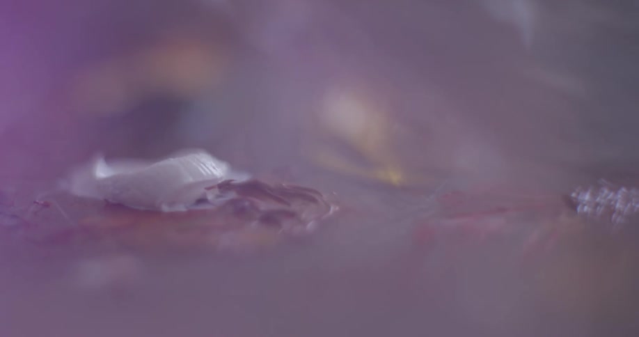 A person putting paint on a palette