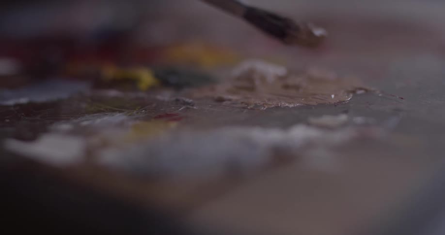A paintbrush dabs at paint