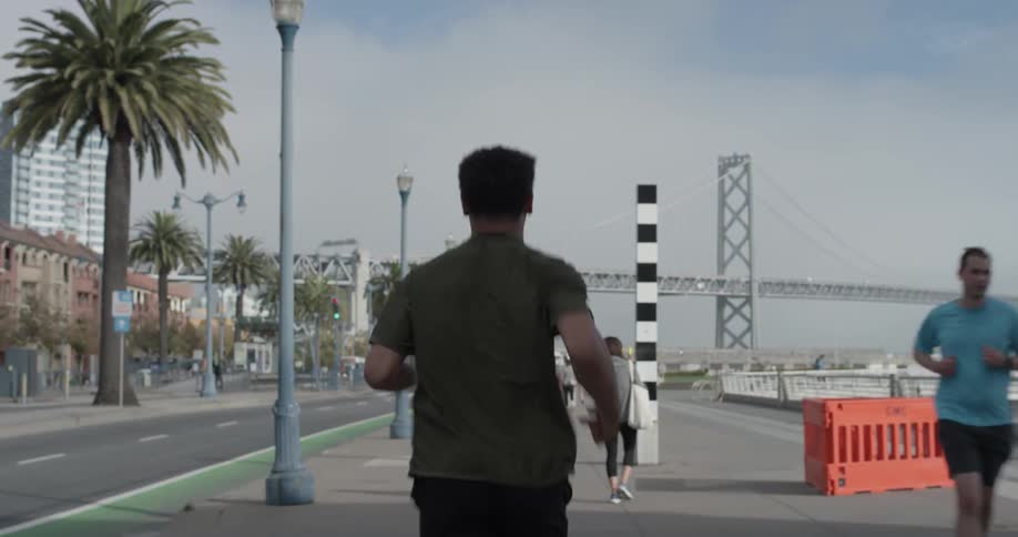 A man running down a sidewalk