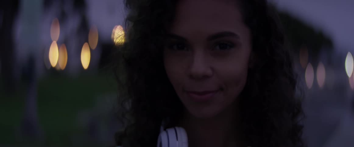 A woman standing in a park at sunset