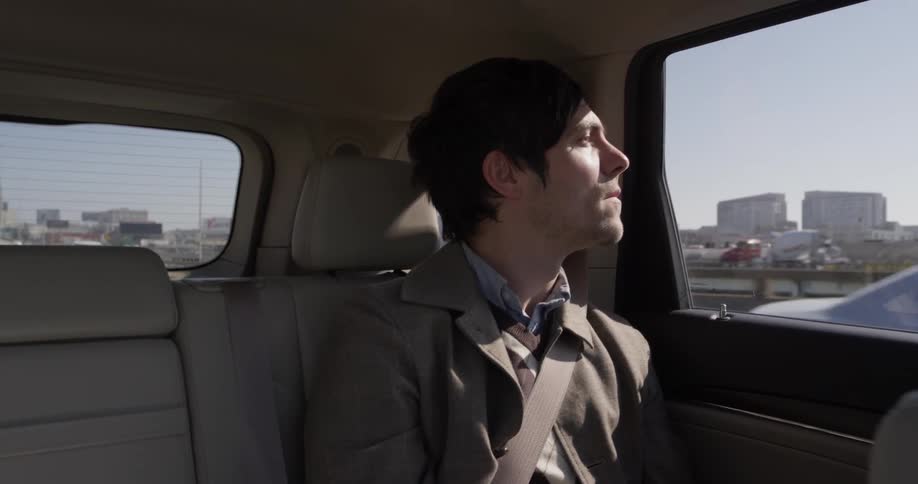 Man rides in backseat of car
