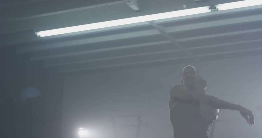 Man stretching in front of a mirror in a gym