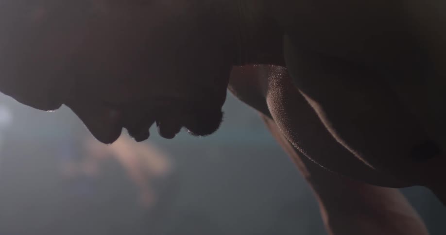 A man sweating while working out in a gym