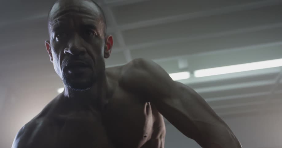 A man is using a dumbbell to do arm curls
