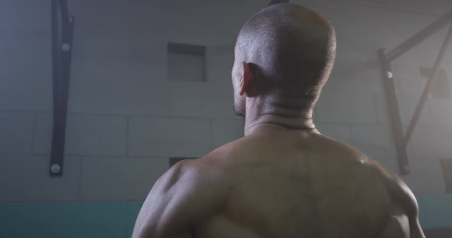 A man walking up to some pull up bars