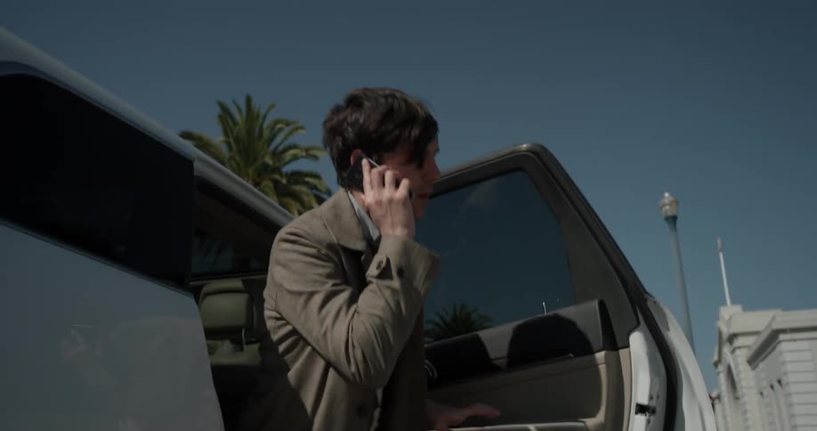 Man getting out of the back seat of a car