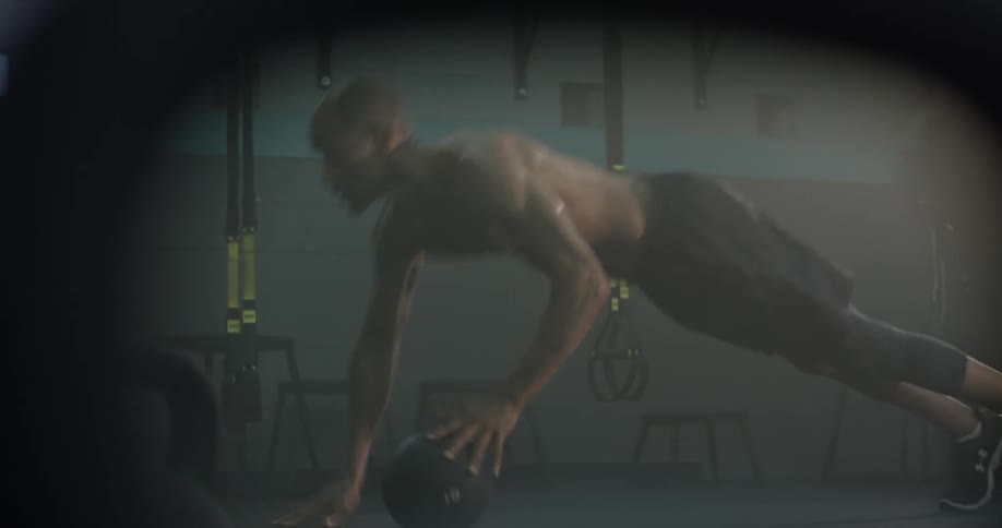 A man doing pushups with a ball
