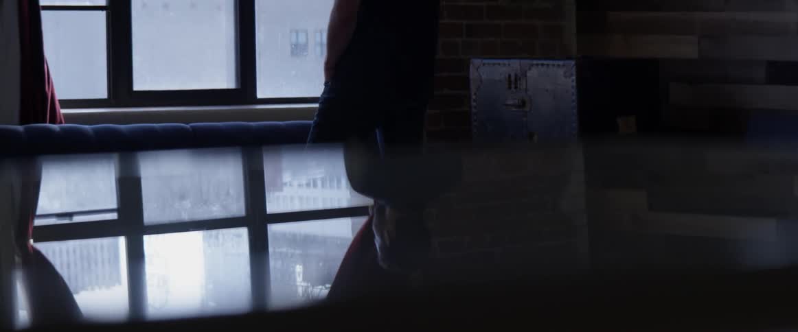 Person's lower half turned towards window