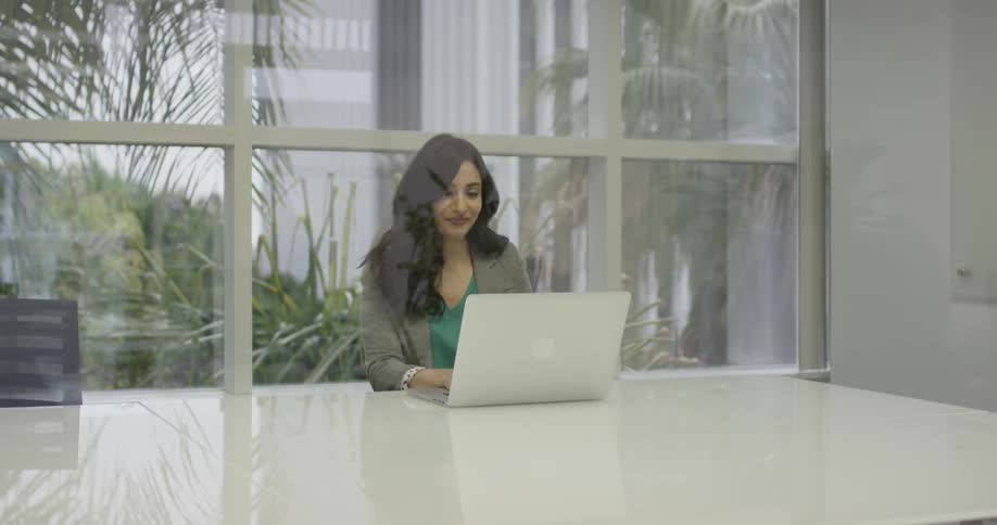 A woman typing on her laptop