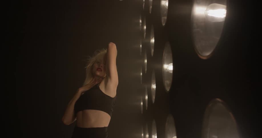 Woman dancing in front of lights