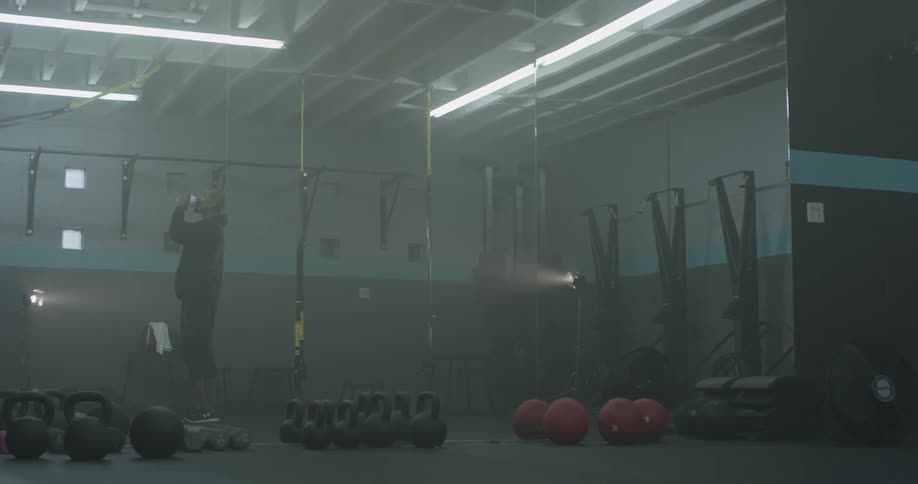 A man drinking water in a gym