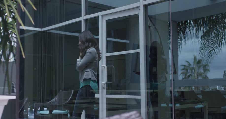 A woman walking out of an office talking on her phone