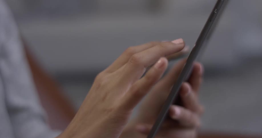 Woman scrolling on a tablet