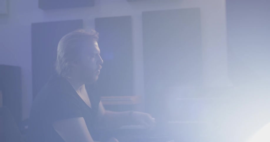 A man working on mixing audio at a studio