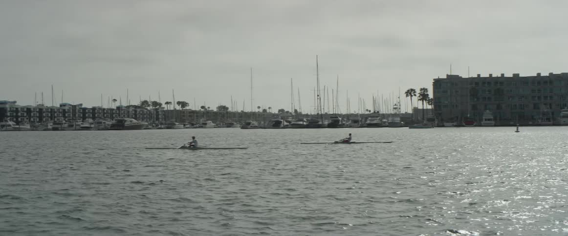 A man rowing a boat down a river