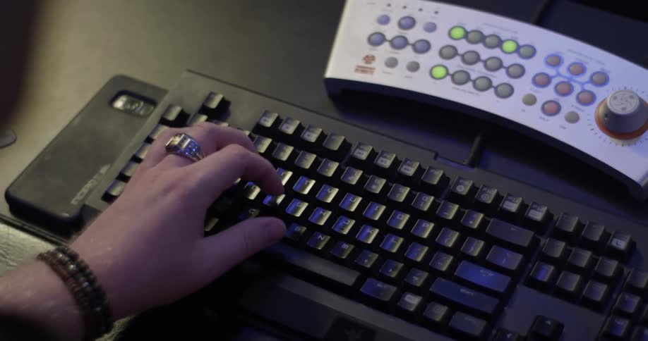 Hand types on black keyboard