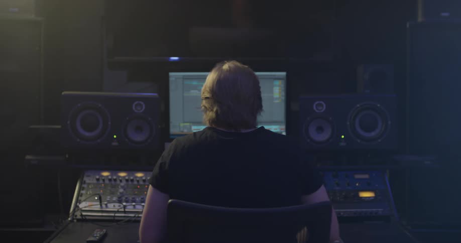 A man using a mixer in a studio