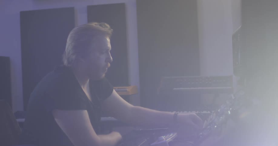 Man messes around with studio equipment