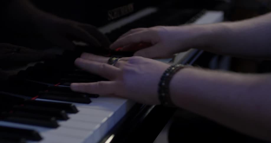 Man bobs his head while playing the piano