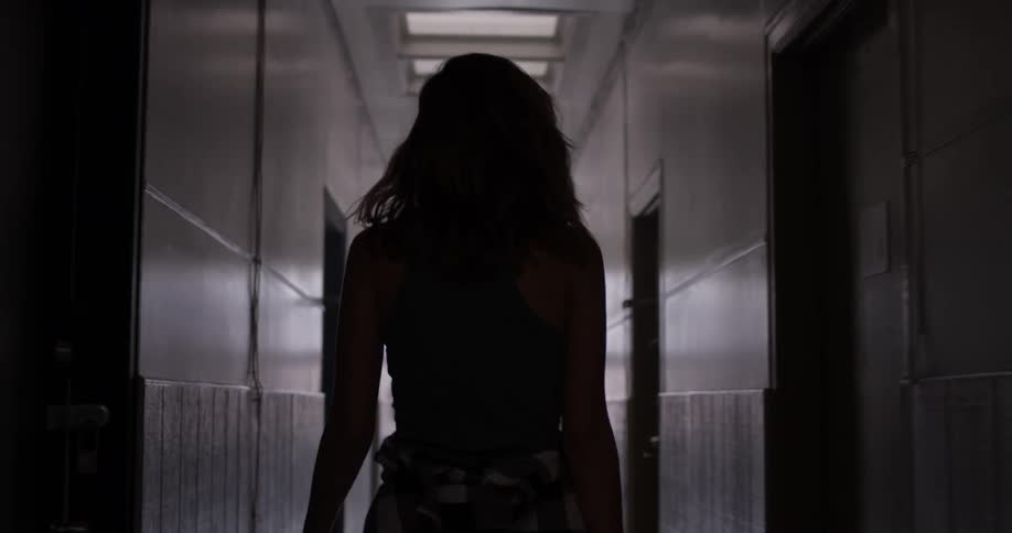 A woman walking down a hallway