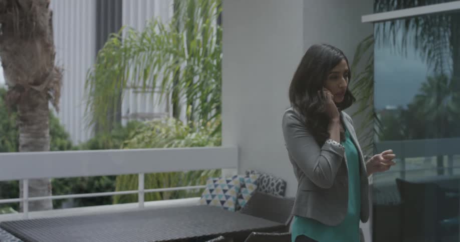 A woman dials a number on her phone and begins to talk