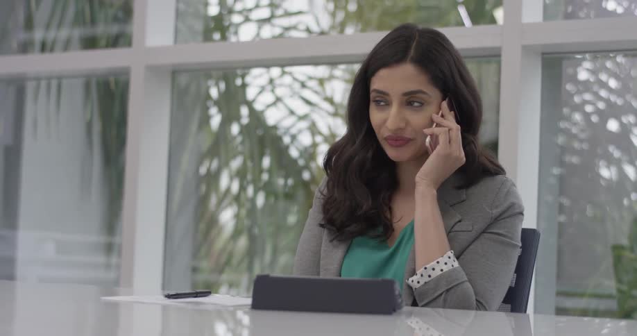 A woman answering a call at work