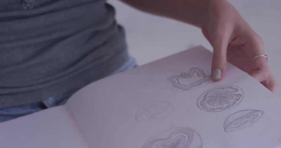 A woman wearing glasses is looking at a book